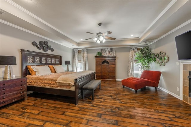 3536 SW Dana Ave, Lees Summit, MO 64082 - bedroom featuring a tray ceiling, wood-type flooring, a tile fireplace, crown molding, and recessed lighting