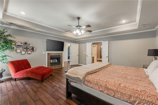 3536 SW Dana Ave, Lees Summit, MO 64082 - bedroom with a tray ceiling, ornamental molding, dark wood finished floors, a fireplace, and recessed lighting