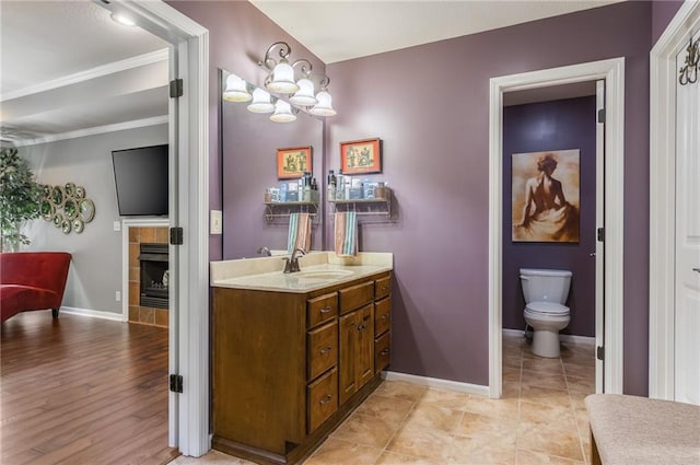 3536 SW Dana Ave, Lees Summit, MO 64082 - bathroom featuring vanity, a tile fireplace, crown molding, and a chandelier