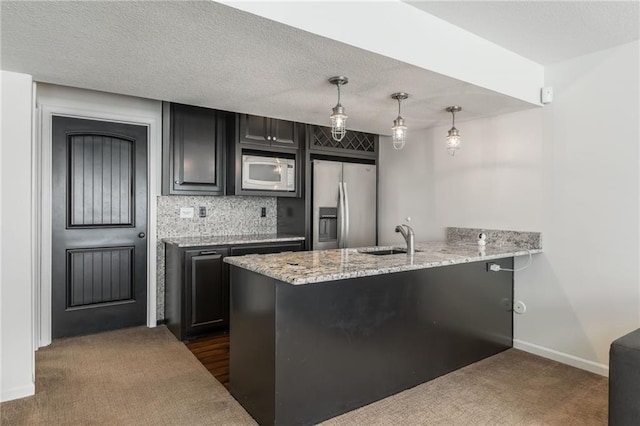 3536 SW Dana Ave, Lees Summit, MO 64082 - kitchen featuring stainless steel refrigerator with ice dispenser, white microwave, a peninsula, dark cabinets, and dark carpet