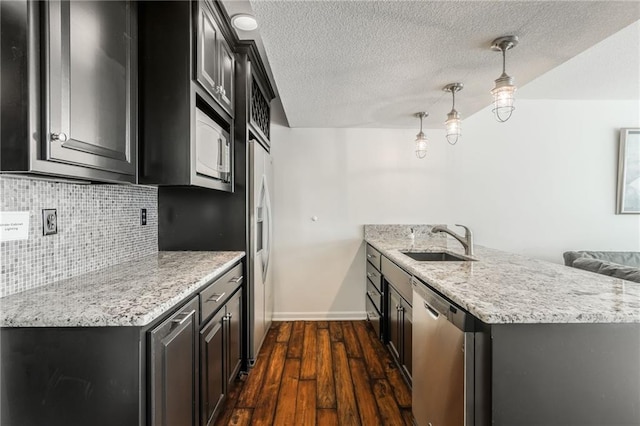 3536 SW Dana Ave, Lees Summit, MO 64082 - kitchen featuring dishwasher, white microwave, dark wood-style flooring, backsplash, and a peninsula