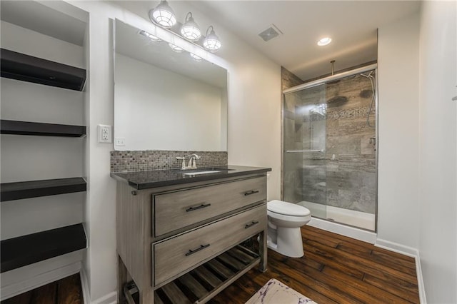 3536 SW Dana Ave, Lees Summit, MO 64082 - full bath featuring a stall shower, vanity, wood finished floors, tasteful backsplash, and recessed lighting