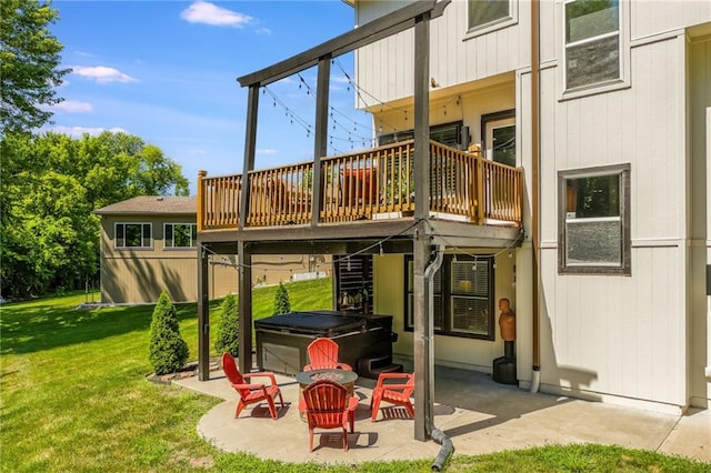 3536 SW Dana Ave, Lees Summit, MO 64082 - rear view of property featuring a hot tub, a patio, a lawn, and a wooden deck