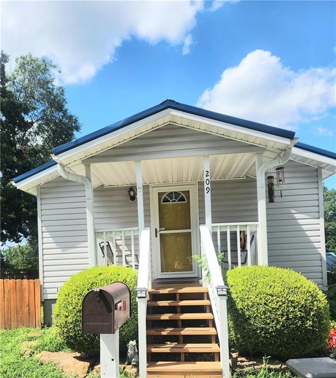 209 W S Railroad St, Knob Noster, MO 65336 - doorway to property featuring covered porch