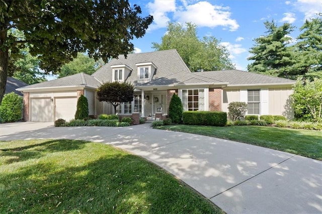 8422 Reinhardt Ln, Leawood, KS 66206 - view of front of home featuring an attached garage, a front lawn, concrete driveway, and brick siding