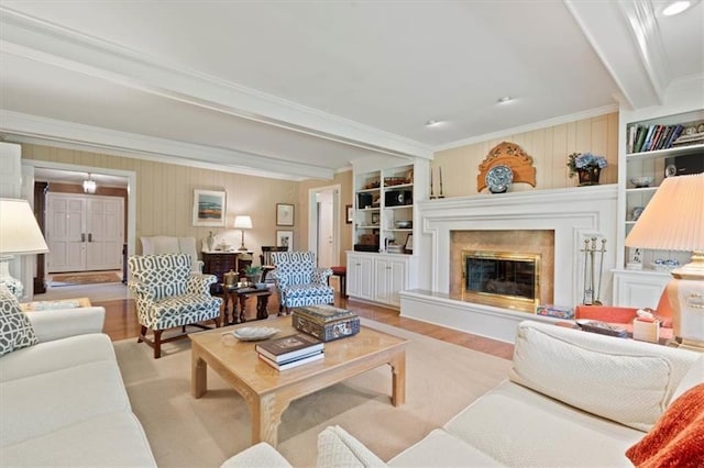 8422 Reinhardt Ln, Leawood, KS 66206 - living area featuring crown molding, wood finished floors, beamed ceiling, a high end fireplace, and built in features