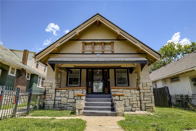3509 Bellefontaine Ave, Kansas City, MO 64128 - victorian house with stone siding, stucco siding, and covered porch