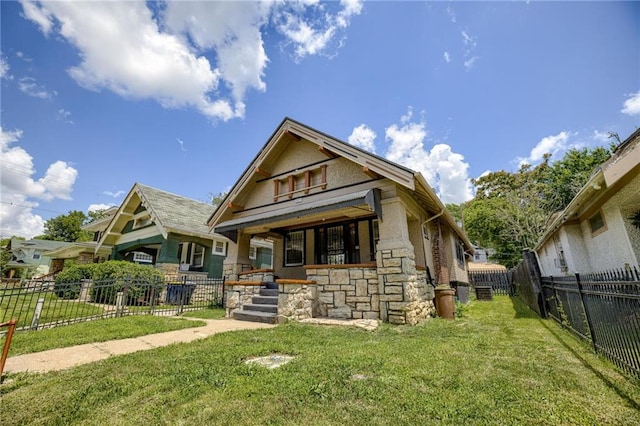 3509 Bellefontaine Ave, Kansas City, MO 64128 - view of front of house featuring stone siding and a fenced backyard