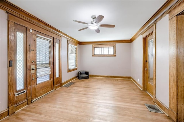 3509 Bellefontaine Ave, Kansas City, MO 64128 - entrance foyer featuring light wood-style flooring, crown molding, and ceiling fan