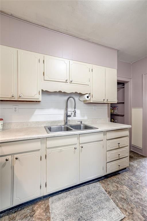 3509 Bellefontaine Ave, Kansas City, MO 64128 - kitchen featuring white cabinetry and light countertops