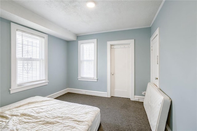 3509 Bellefontaine Ave, Kansas City, MO 64128 - bedroom with a textured ceiling, dark colored carpet, and crown molding