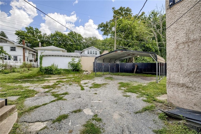 3509 Bellefontaine Ave, Kansas City, MO 64128 - view of yard with a detached carport and driveway