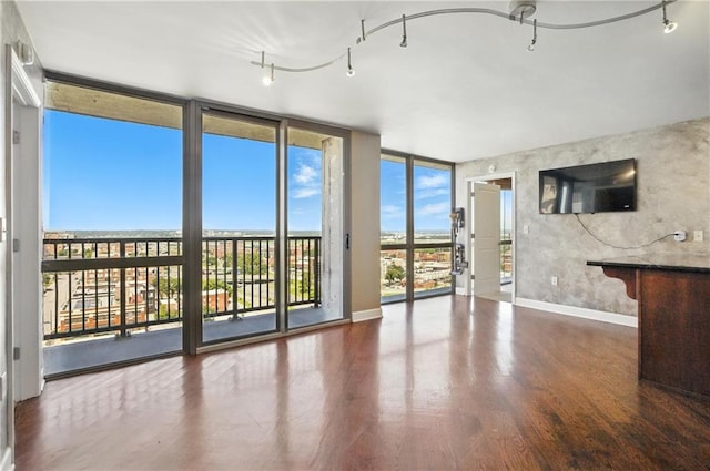 600 E Admiral Blvd Unit 1703, Kansas City, MO 64106 - unfurnished living room featuring floor to ceiling windows and wood finished floors