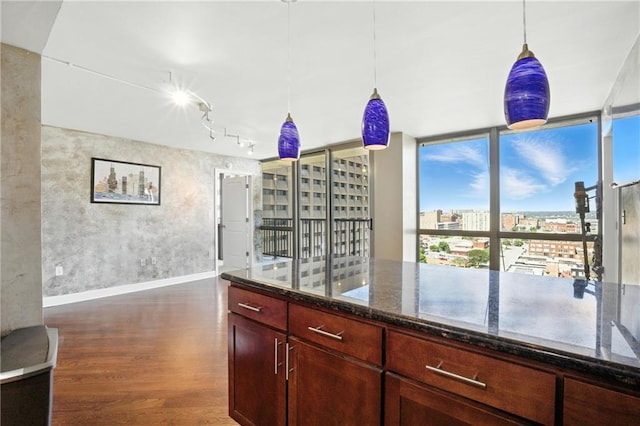 600 E Admiral Blvd Unit 1703, Kansas City, MO 64106 - kitchen featuring dark wood-type flooring, dark stone counters, pendant lighting, and track lighting