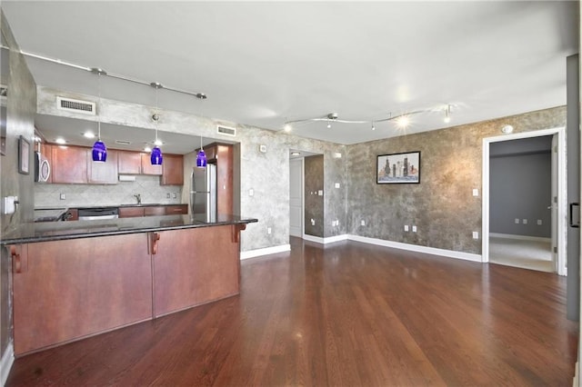 600 E Admiral Blvd Unit 1703, Kansas City, MO 64106 - kitchen with stainless steel appliances, dark countertops, dark wood finished floors, open floor plan, and a peninsula