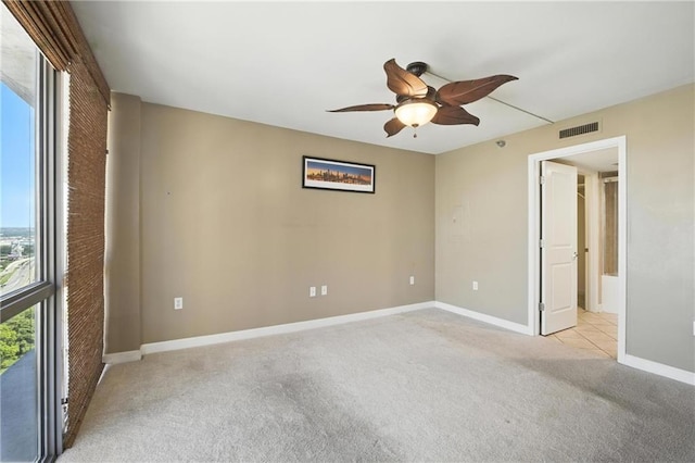 600 E Admiral Blvd Unit 1703, Kansas City, MO 64106 - unfurnished bedroom featuring light carpet, ceiling fan, and ensuite bathroom