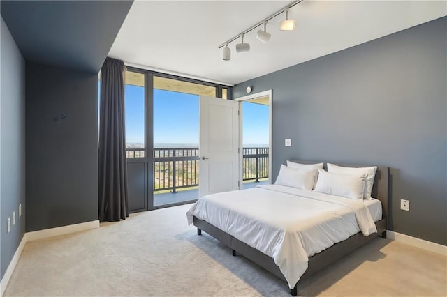 600 E Admiral Blvd Unit 1703, Kansas City, MO 64106 - bedroom with access to exterior, track lighting, carpet flooring, and a water view