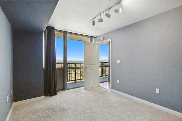 600 E Admiral Blvd Unit 1703, Kansas City, MO 64106 - carpeted empty room featuring floor to ceiling windows and track lighting