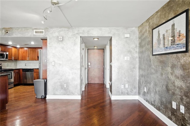 600 E Admiral Blvd Unit 1703, Kansas City, MO 64106 - kitchen with stainless steel appliances, dark wood-style flooring, rail lighting, and brown cabinets
