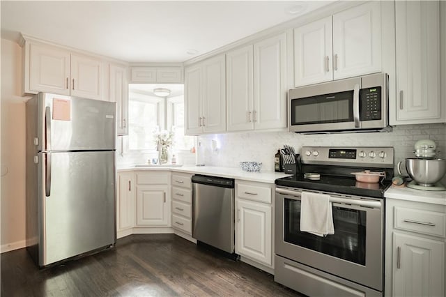 6015 W 78th Ter, Prairie Village, KS 66208 - kitchen with appliances with stainless steel finishes, tasteful backsplash, dark wood-style floors, light countertops, and white cabinets