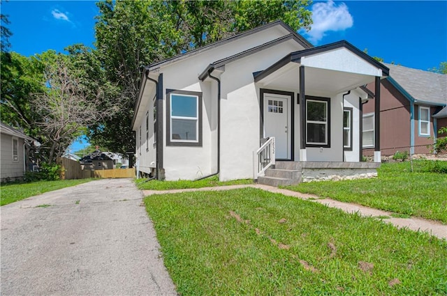 1832 N 31st St, Kansas City, KS 66104 - view of front of home featuring stucco siding and asphalt driveway