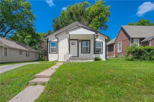 1832 N 31st St, Kansas City, KS 66104 - view of front of house featuring a front yard and stucco siding