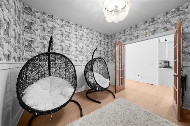118 NW Grady Ct, Lees Summit, MO 64081 - living area with wallpapered walls, a wainscoted wall, and wood finished floors