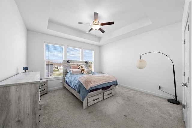 118 NW Grady Ct, Lees Summit, MO 64081 - bedroom featuring a raised ceiling, light carpet, and a ceiling fan
