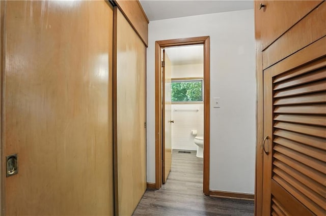 7604 Tomahawk Rd, Prairie Village, KS 66208 - hallway with wood finished floors and tile walls