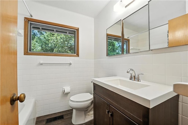 7604 Tomahawk Rd, Prairie Village, KS 66208 - bathroom with tile walls, vanity, wood finished floors, and tub / shower combination