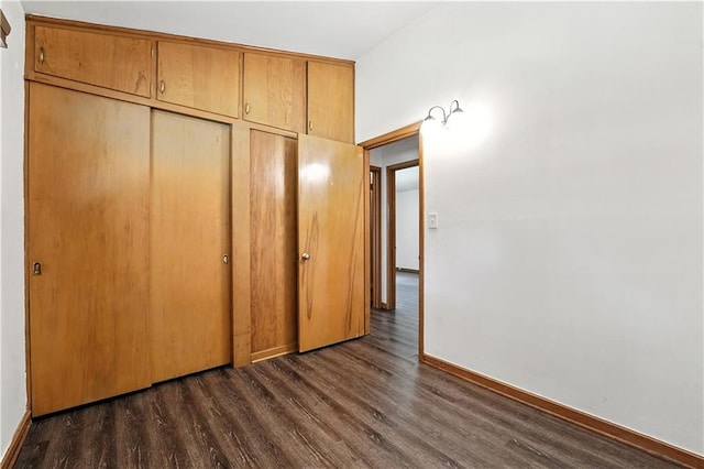 7604 Tomahawk Rd, Prairie Village, KS 66208 - unfurnished bedroom featuring dark wood-style flooring and a closet