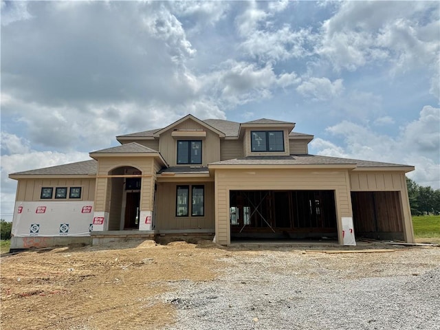 8325 NE 86th Ter, Kansas City, MO 64158 - property under construction with roof with shingles, gravel driveway, an attached garage, and a porch