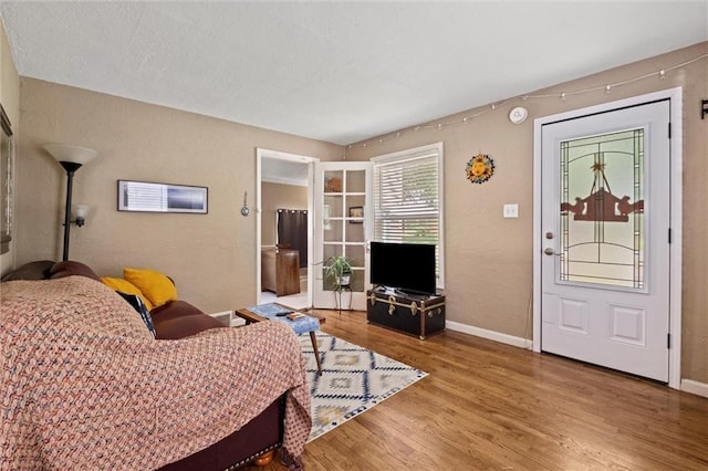6016 Harrison St, Kansas City, MO 64110 - living area featuring wood finished floors and a textured wall