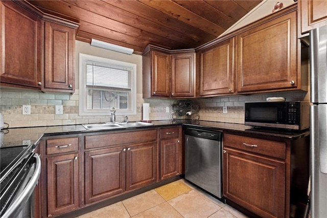 6016 Harrison St, Kansas City, MO 64110 - kitchen with appliances with stainless steel finishes, wood ceiling, light tile patterned floors, tasteful backsplash, and brown cabinets