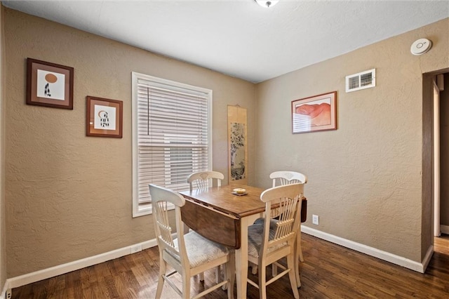 6016 Harrison St, Kansas City, MO 64110 - dining room with wood finished floors and a textured wall