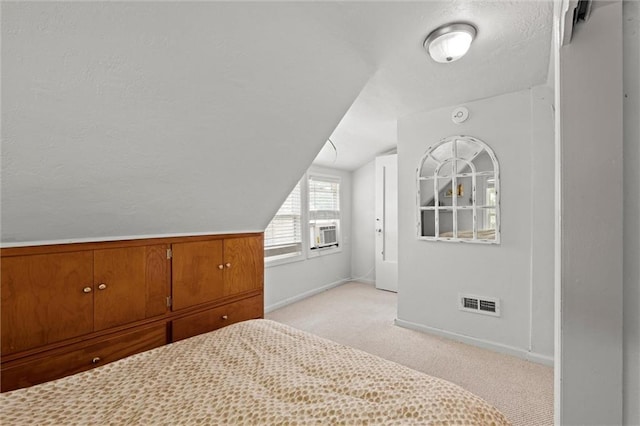 6016 Harrison St, Kansas City, MO 64110 - bedroom with light carpet, vaulted ceiling, and cooling unit