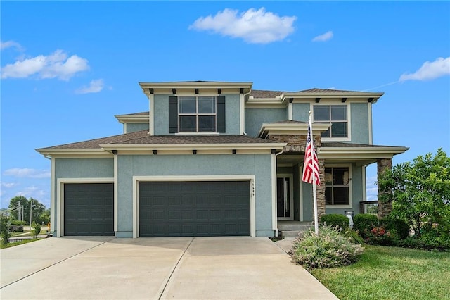 16699 S Chalet Dr, Olathe, KS 66062 - prairie-style home featuring driveway, stucco siding, an attached garage, a porch, and a garage