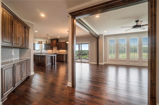 16699 S Chalet Dr, Olathe, KS 66062 - unfurnished living room featuring crown molding, ceiling fan, dark wood-style flooring, and recessed lighting