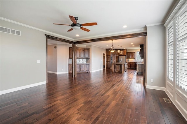 16699 S Chalet Dr, Olathe, KS 66062 - unfurnished living room featuring dark wood-type flooring, ceiling fan, plenty of natural light, crown molding, and recessed lighting