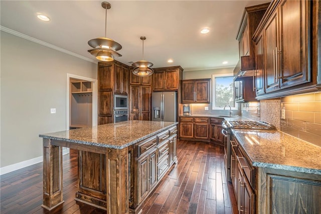 16699 S Chalet Dr, Olathe, KS 66062 - kitchen featuring crown molding, dark wood finished floors, stainless steel appliances, dark stone countertops, and a center island