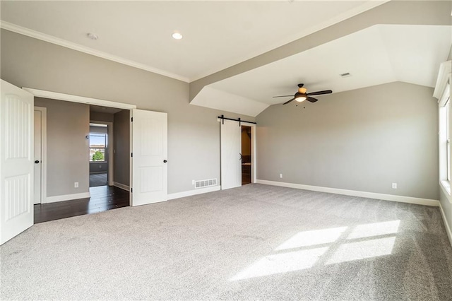 16699 S Chalet Dr, Olathe, KS 66062 - unfurnished bedroom featuring dark carpet, a barn door, vaulted ceiling, a ceiling fan, and ornamental molding