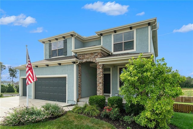16699 S Chalet Dr, Olathe, KS 66062 - view of front facade with stucco siding, stone siding, driveway, and a garage