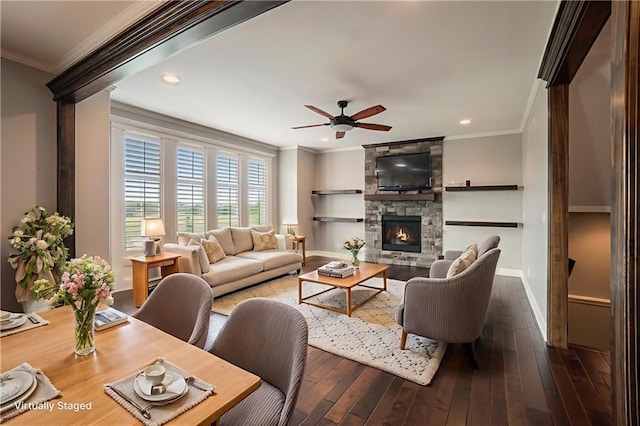 16699 S Chalet Dr, Olathe, KS 66062 - living room with crown molding, a ceiling fan, dark wood-style flooring, a fireplace, and recessed lighting