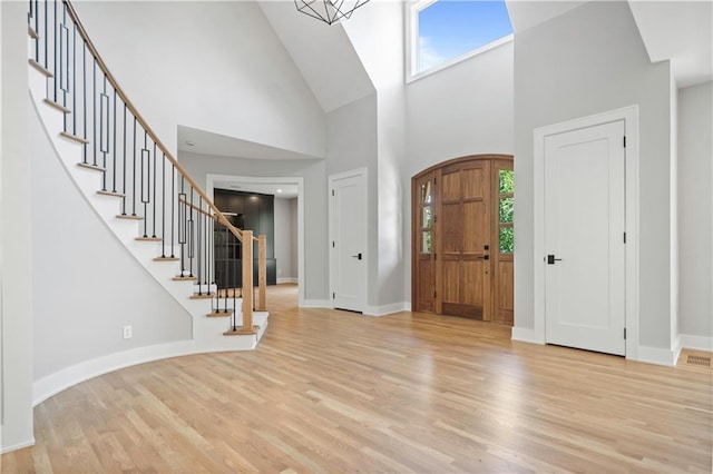 2616 W 112th St, Leawood, KS 66211 - entryway with high vaulted ceiling, light wood-style floors, and stairs