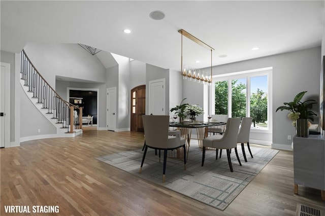 2616 W 112th St, Leawood, KS 66211 - dining space with light wood-type flooring, recessed lighting, and stairway