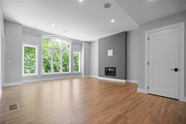 2616 W 112th St, Leawood, KS 66211 - unfurnished living room with light wood-style floors, recessed lighting, and a fireplace
