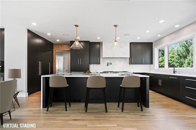 2616 W 112th St, Leawood, KS 66211 - kitchen featuring dark cabinets, modern cabinets, decorative backsplash, a center island, and recessed lighting