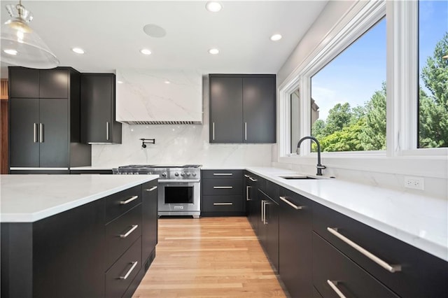 2616 W 112th St, Leawood, KS 66211 - kitchen featuring stainless steel stove, dark cabinets, premium range hood, light countertops, and recessed lighting