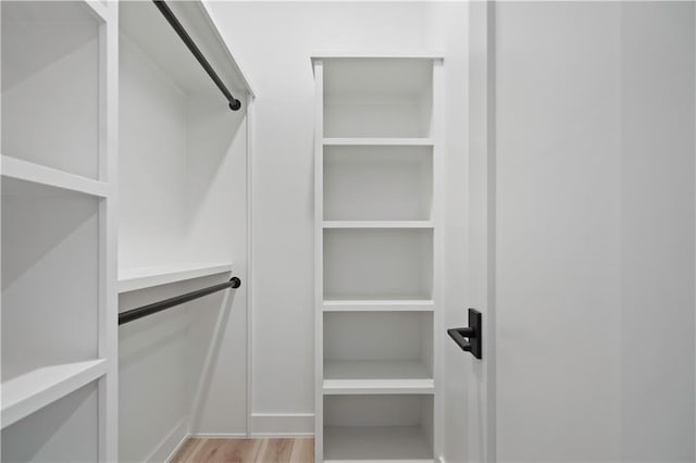 2616 W 112th St, Leawood, KS 66211 - walk in closet with light wood-style flooring