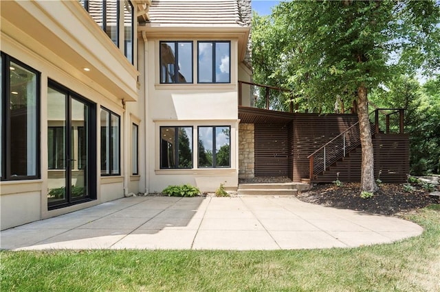 2616 W 112th St, Leawood, KS 66211 - back of property featuring a patio area, stucco siding, and stone siding